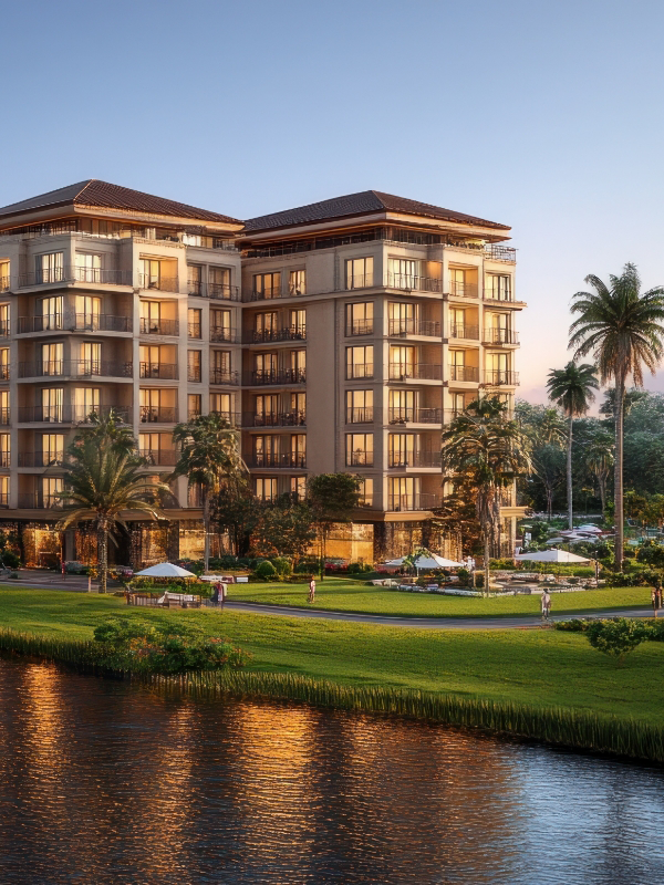 A tall commercial building surrounded by palm trees and green grass, kept in top shape by commercial property management services.